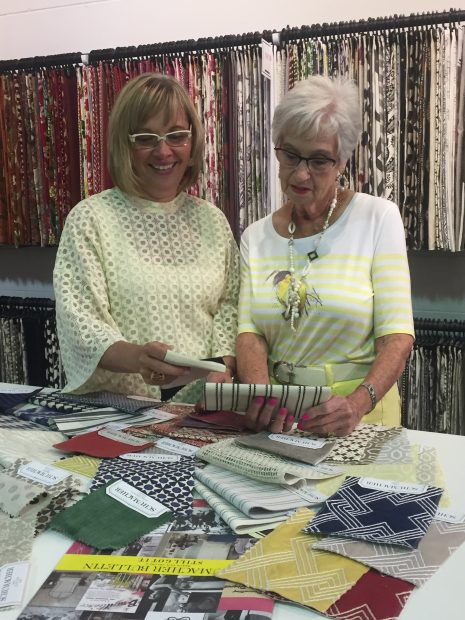 Stewart Drummond Studios Fabric showroom with Audrey and Shelley looking over the latest Schumacher collection