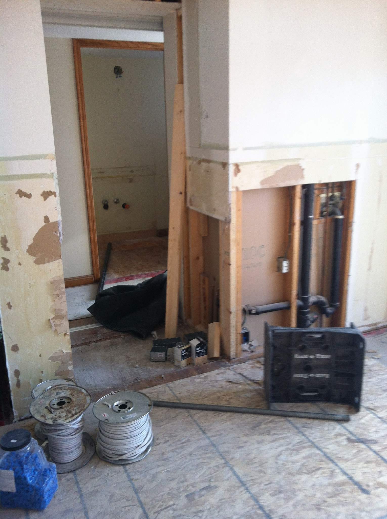 View of wet bar removed and plumbing section of wall