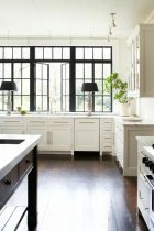 black window above kitchen sink adds drama to a white kitchen